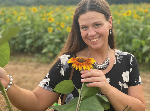 Irvine Nursing and Rehab employee Tiffany Jones pictured in sunflower field