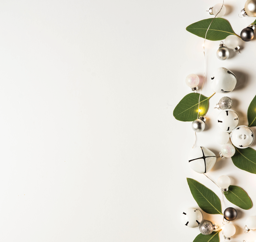image of jingle bells and green leaves on a white background