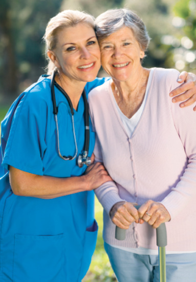 Older-adult woman standing with female nurse