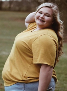 Young woman posing, smiling for photo. Irvine Nursing and Rehab staff member, Payton.
